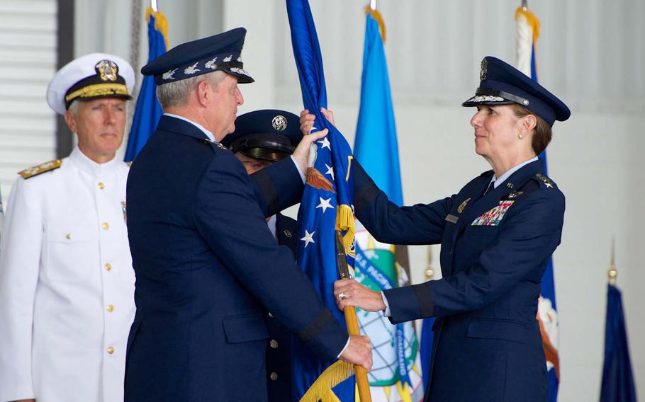 Gen. Lori Robinson, Pacific Air Forces commander, receives the PACAF flag from Air Force Chief of Staff Gen. Mark A. Welsh III during the PACAF change of command ceremony at Joint Base Pearl Harbor-Hickam, Hawaii, Oct. 16, 2014. Robinson now leads U.S. Air Force activities spread over half the globe in a command that supports 46,000 Airmen serving principally in Japan, Korea, Hawaii, Alaska and Guam.
