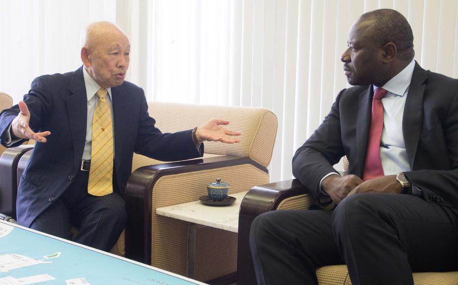 In this photo from the Comprehensive Nuclear-Test-Ban Treaty Organization, Keijiro Matsushima, left, a survivor of the atomic bombing of Hiroshima, talks with CTBTO Executive Secretary Lassina Zerbo during Zerbo's visit to Japan in November 2013. 
