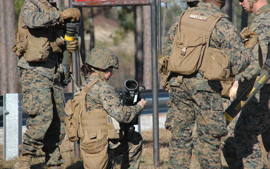 A female Marine assembles a rocket launcher at Camp Lejeune, N.C.
