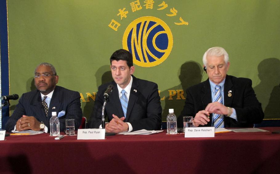 Rep. Paul Ryan, R-Wisc., center, speaks with reporters about the Trans-Pacific Partnership on Thursday, Feb. 19, 2015, in Tokyo. Ryan and seven other congressmen were scheduled to meet with Japanese Prime Minister Shinzo Abe later in the day.