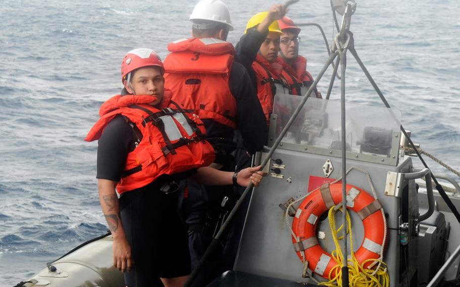 Petty Officer 2nd Class Richard Chavez, a search-and-rescue swimmer attached to the U.S. 7th Fleet flagship USS Blue Ridge, prepares to take part in the rescue of five Philippine fishermen. 