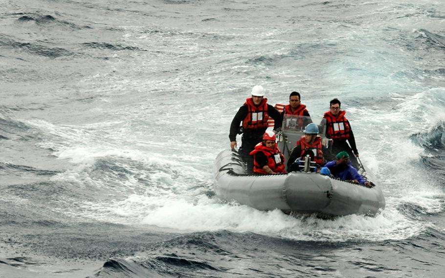 U.S. sailors head to a boat carrying stranded Philippine fishermen. The sailors are attached to the U.S. 7th Fleet flagship USS Blue Ridge.