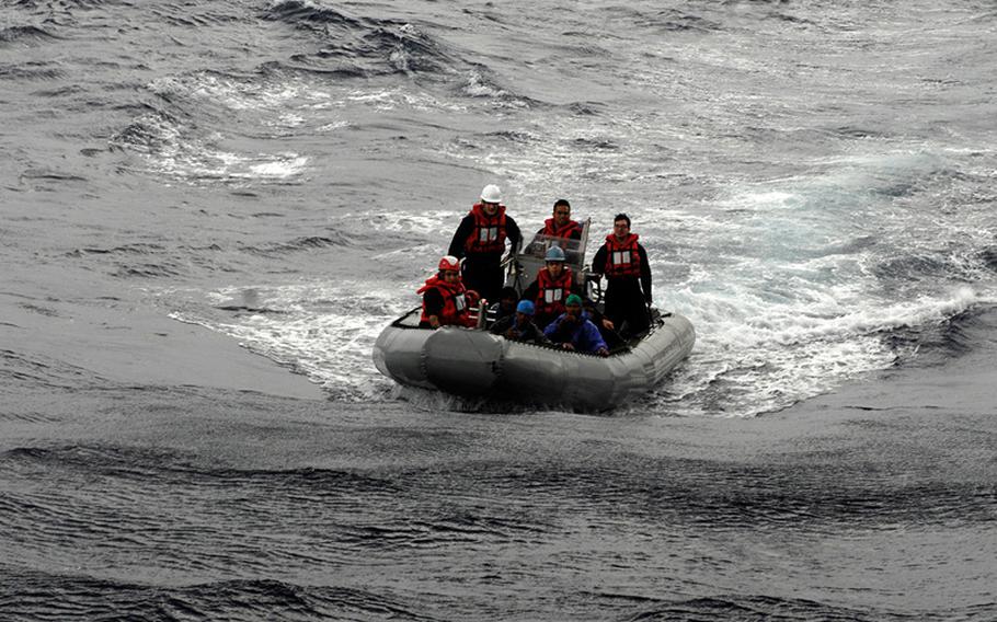 Sailors attached to the U.S. 7th Fleet flagship USS Blue Ridge speed toward a boat carrying five Philippine fishermen, who were stranded when their fishing boat suffered a mechanical problem. 