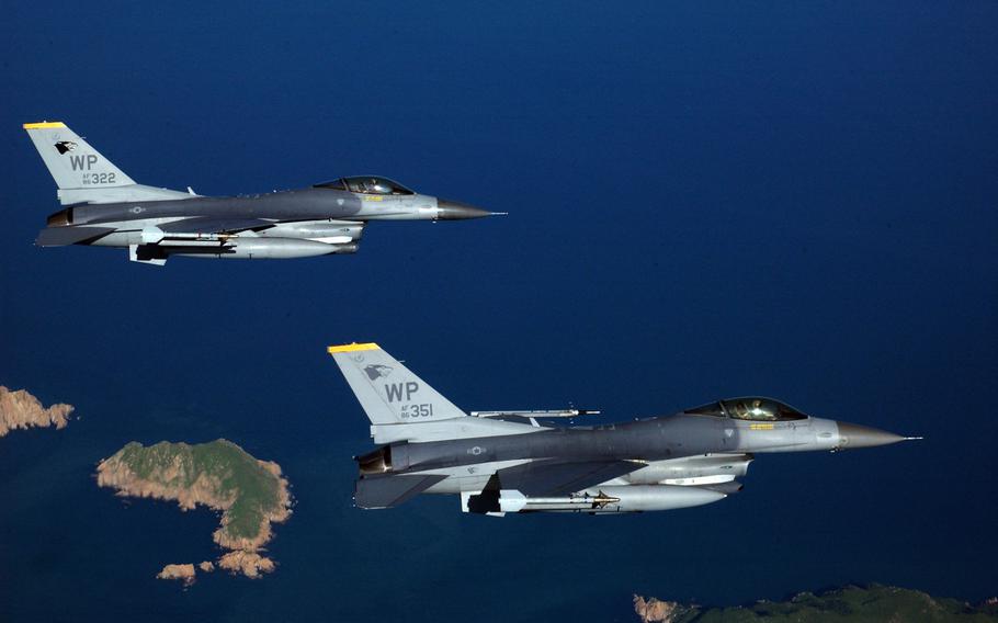 Two F-16 Fighting Falcon aircraft fly to a range on Kunsan Air Base, Korea, on Aug. 15, 2006.  