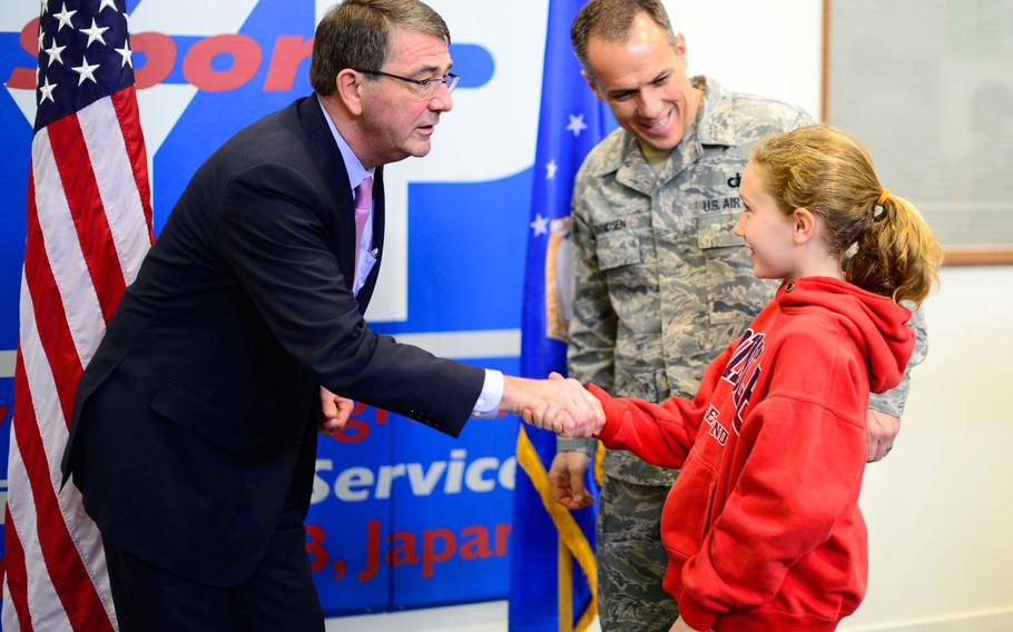 Defense Secretary Ash Carter greets children and families at Yokota Air Base, Japan, on Thursday, April 9, 2015, after a short town hall with troops. Carter was scheduled to travel to Osan Air Base, South Korea, later in the day.