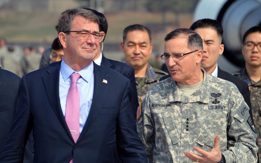 Gen. Curtis Scaparrotti, U.S. Forces Korea commander, speaks with Defense Secretary Ash Carter as they walk down the flight line at Osan Air Base, South Korea on April 9, 2015.
