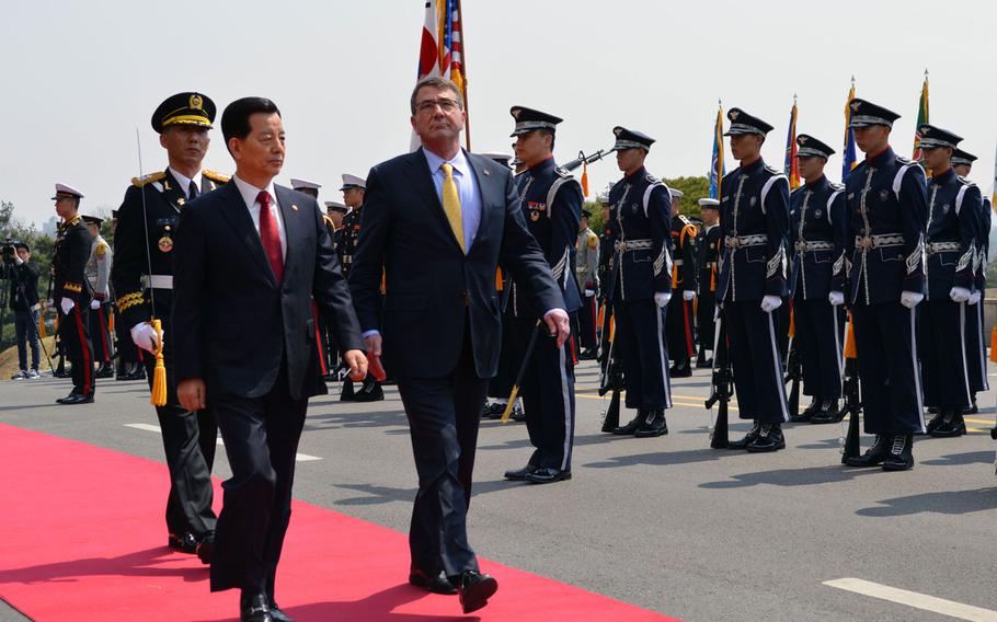 Defense Secretary Ash Carter, right, walks alongside South Korean Defense Minister Han Minkoo during a ceremonial review at the Ministry of National Defense in Seoul on Friday, April 10, 2015. After the ceremony, Carter gave a speech about the Asia-Pacific region.