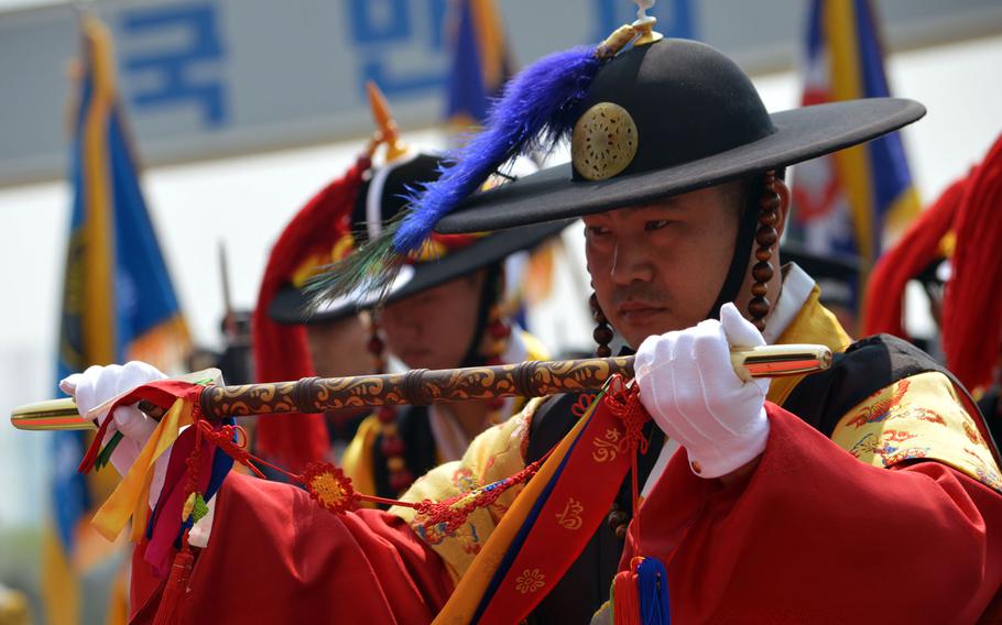 A South Korean in ceremonial dress stands in respect during the playing of the U.S. and South Korean national anthems at the Ministry of National Defense in Seoul on Friday, April 10, 2015. Defense Secretary Ash Carter was present during the ceremony.