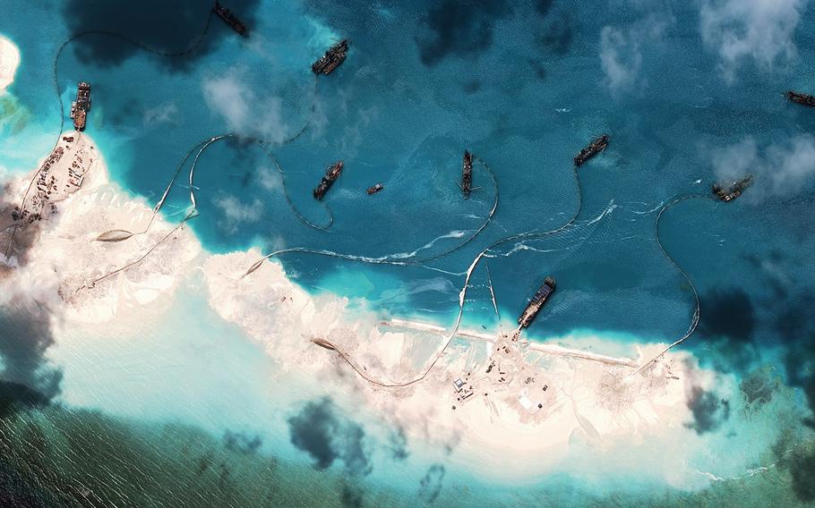 According to the Asia Maritime Transparency Initiative report, this image dated March 16, 2015, shows a chain of artificial land formations, along with new structures, fortified seawalls and construction equipment in the South China Sea.