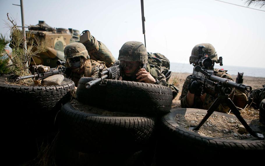 U.S. Marines provide security during a beach landing exercise with Republic of Korea  Marines on BLA White Beach, Pohang, South Korea, March 30, 2015.