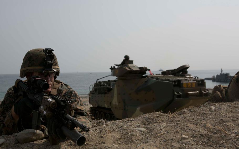 U.S. Marine Corps Cpl. Gary Johnston provides security during a beach landing exercise with Republic of Korea   Marines on BLA White Beach, Pohang, South Korea, March 29, 2015. 