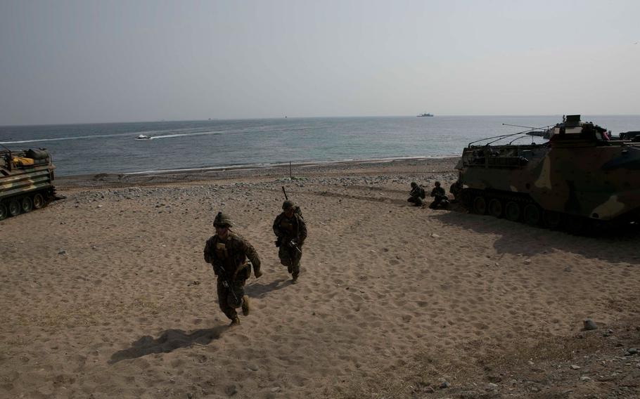 U.S. Marines run to their positions during a beach landing exercise with Republic of Korea Marines on BLA White Beach, Pohang, South Korea, March 29, 2015.