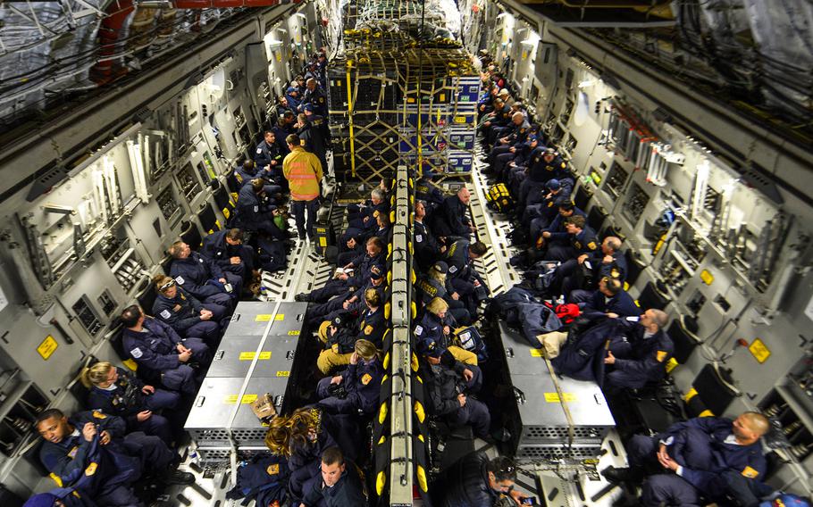 Sixty-nine members of the Fairfax County Urban Search and Rescue Team await takeoff on a U.S. Air Force C-17 Globemaster III at Dover Air Force Base, Del., April 26, 2015. The specially trained team and approximately 70,000 pounds of their supplies are deploying to Nepal to assist with rescue operations after the country was struck by a 7.8-magnitude earthquake. 