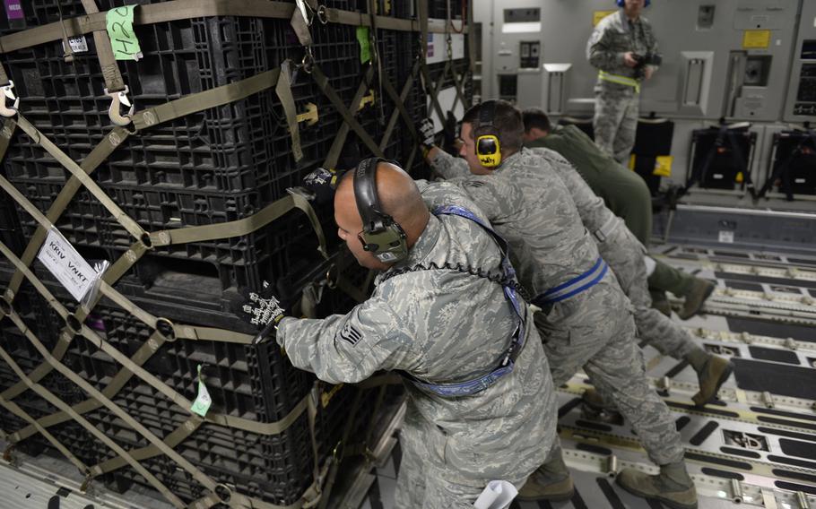 U.S. Air Force personnel load relief supplies for victims of the Nepal earthquake into a USAF C-17 Globemaster III from Joint Base Charleston, S.C., at March Air Force Base, Calif., April 26, 2015. The U.S. Agency of International Development relief cargo included eight pallets, 59 Los Angeles County Fire Department personnel and five search and rescue dogs.