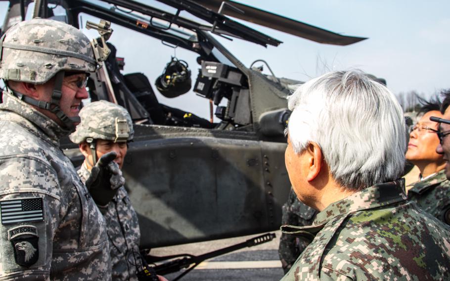 Col. Hank Taylor, the 2nd Combat Aviation Brigade commander, left, speaks with South Korean Lt. Gen. Kim, center during the Key Resolve exercise March 11, 2015, in South Korea.  Units from the two armies have been integrating this spring to form a combined fighting unit north of Seoul.

