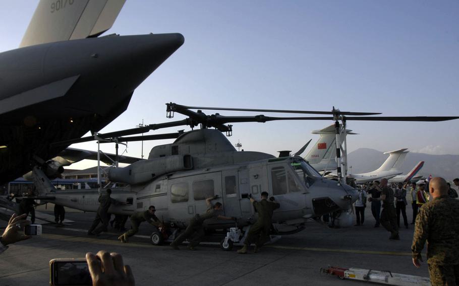 U.S. Marines unload a UH-2 Huey helicopter from a C-17 cargo jet at Kathmandu's airport on Sunday, May 3, 2015. The U.S. aircraft and personnel are to help in Nepal's earthquake relief effort. 
