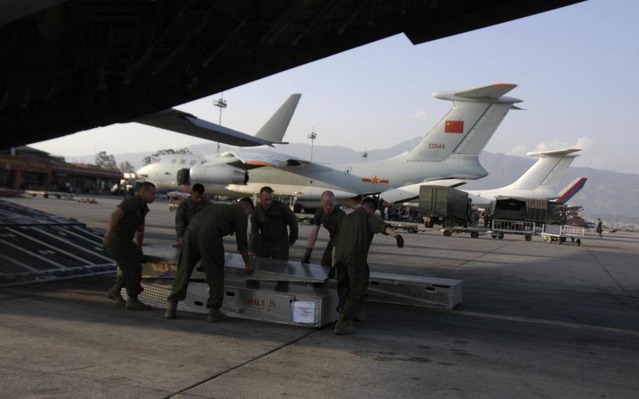 Marines unload an Air Force C-17 transport plane at Kathmandu, Nepal on Sunday, May 3, 2015.  The U.S. brought in aircraft and troops to help with the relief effort following the April 25 earthquake.

