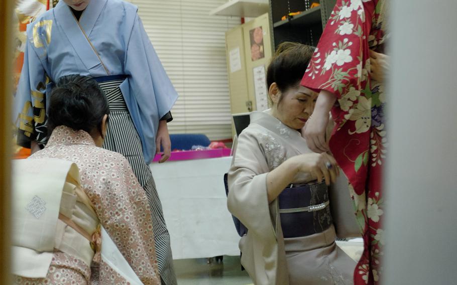 Ryan Decker and Autumn Sparks of Joan K. Mendel Elementary School in Yokota Air Base, Japan practice "kimono kitsuke," or the art of wearing Japanese traditional dress, May 5, 2015 during the school's annual cultural festival, JapANDasia. More than 160 volunteers participated in the festival to teach the elementary school students about Japanese culture and language.