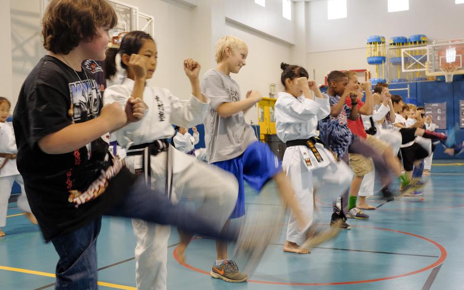 Students from Busonjuku, a local karate school, and Joan K. Mendel Elementary School of Yokota Air Base, Japan practice the martial art together May 5, 2015 during the school's annual cultural festival, JapANDasia. More than 160 volunteers participated in the festival to teach the elementary school students about Japanese culture and language.