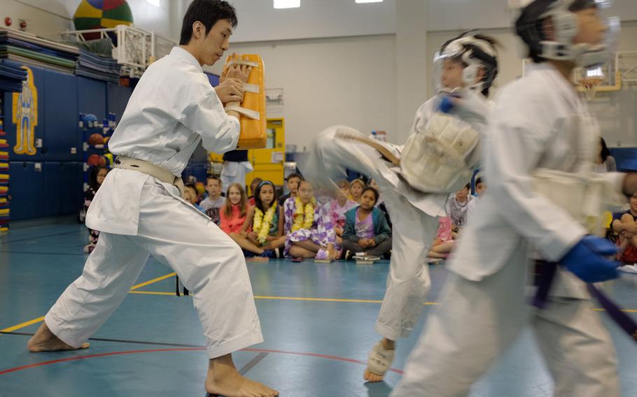 Students from Busonjuku, a local karate school, demonstrate the martial art May 5, 2015 during Joan K. Mendel Elementary School's annual cultural festival, JapANDasia at Yokota Air Base, Japan. More than 160 volunteers participated in the festival to teach the elementary school students about Japanese culture and language.