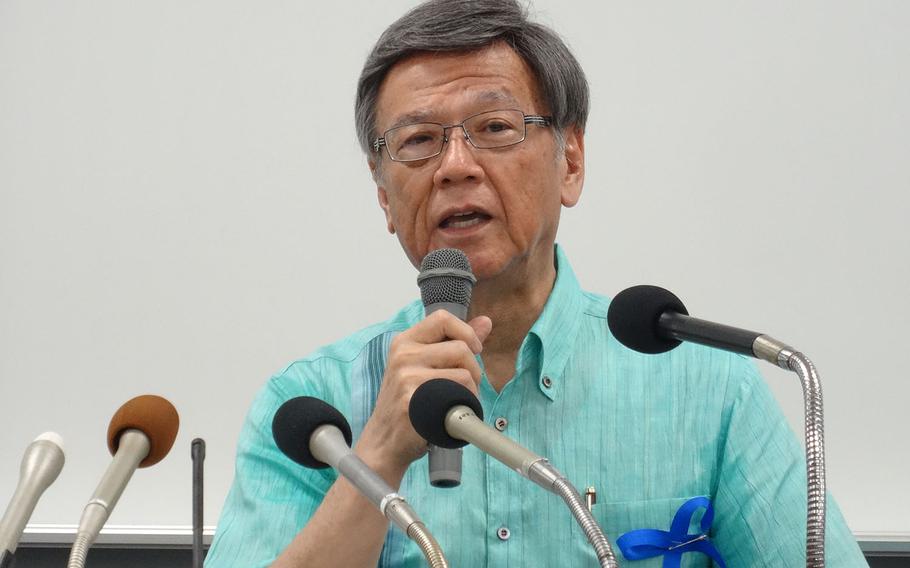Okinawa Gov. Takeshi Onaga tells reporters after a rally against a new runway at Camp Schwab that he will convey the island's opposition to the project during his planned visit to the United States next month, Sunday, May 17, 2015.