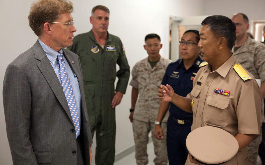 W. Patrick Murphy, the U.S. chargé d'affaires to Thailand, and Royal Thai Navy Rear Adm. Graisrl Gesom speak at the Thai-U.S. humanitarian aid and disaster relief Combined Coordination Center for Nepal in Utapao, Thailand, May 14, 2015. 