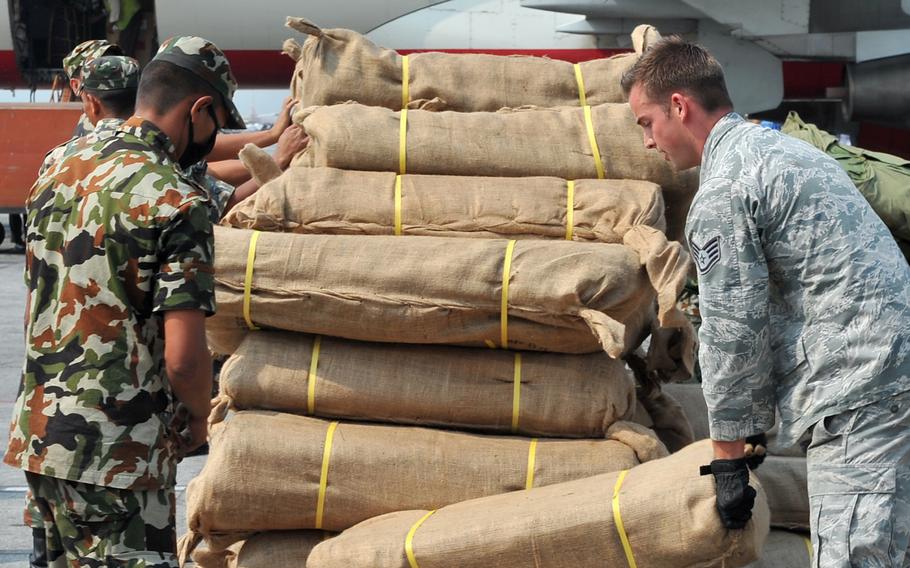 A Nepalese soldier and Staff Sgt. Josh Foley, 36th Mobility Response Squadron aerial port supervisor, move relief supplies May 7, 2015, at the Kathmandu international airport in Nepal. The U.S. military has ended the aid mission it launched in Nepal following last month’s earthquake and personnel are in the process of leaving the country.