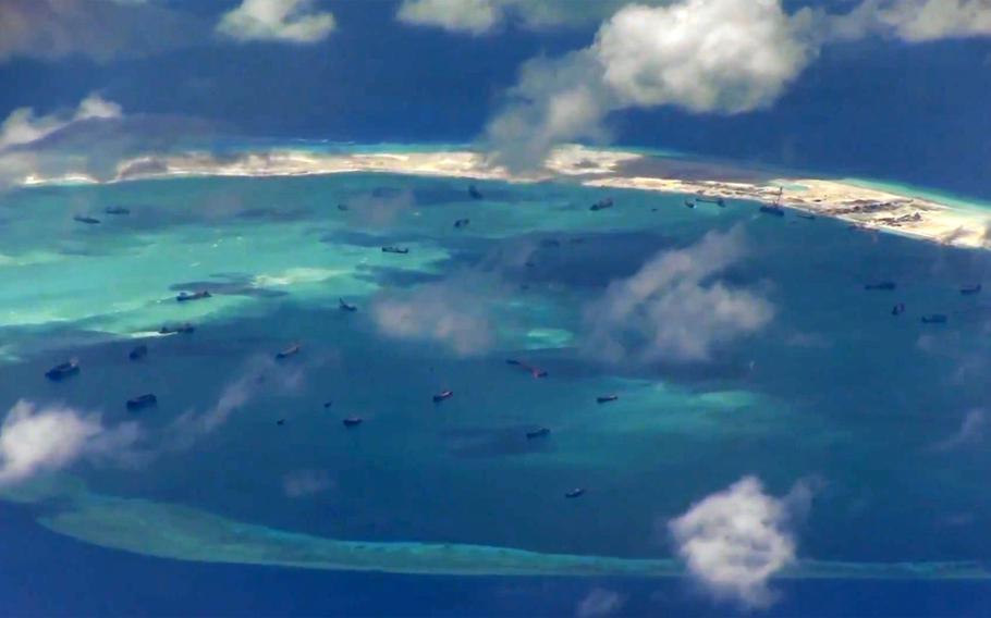 In this screen capture from U.S. Navy-released video, sailors conduct flight operations aboard a Navy P-8A Poseidon over the South China Sea on Wednesday, May 20, 2015. During the flight, the crew of the Poseidon documented several warnings by the Chinese navy to leave the area.