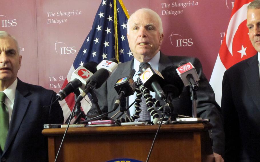 Sen. John McCain tells reporters that the U.S. must encourage China to settle its disputes over the South China Sea with diplomacy, and not coercion, at the Shangri-La Dialogue in Singapore on Saturday, May 30, 2015.