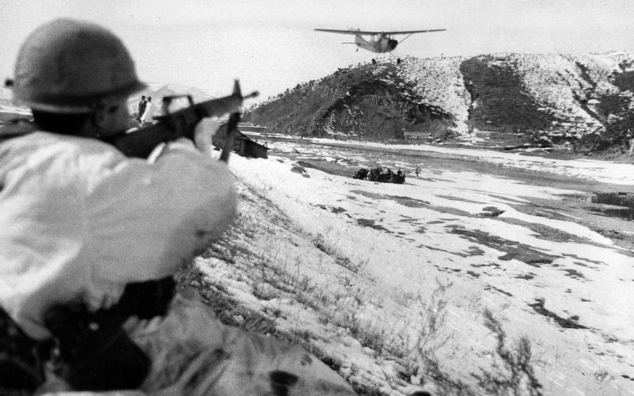 A 1st Brigade Combat Team rifleman aims his weapon at a reconnaissance plane simulating a fighter attack on a grounded vehicle on Feb. 24, 1969, in South Korea.