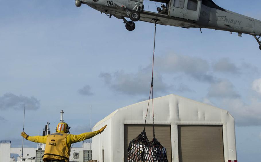 Hospital ship USNS Mercy receives supplies at sea while underway to Papua New Guinea Friday for Pacific Partnership 2015 missions.  Pacific Partnership is the largest annual multilateral humanitarian assistance and disaster relief preparedness mission conducted in the Indo-Asia-Pacific region. 