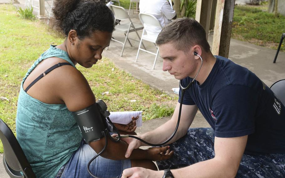 Hospital Corpsman Brandon Butler takes a patientâ€™s vital signs Sunday at a surgical screening during Pacific Partnership 2015 in Arawa, Papua New Guinea. While training for crisis conditions, Pacific Partnership missions to date have provided medical care to approximately 270,000 patients and veterinary services to more than 38,000 animals. They also have provided critical infrastructure development to host nations through the completion of more than 180 engineering projects.
