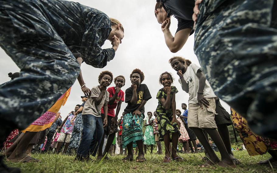 Children dance with servicemembers from hospital ship USNS Mercy on Sunday during Pacific Partnership 2015 in Arawa, Papua New Guinea. Mercy is being supported by USNS Millinocket -- part of the U.S. Military Sealift Command -- which arrived last week in Micronesia for a two-week mission.