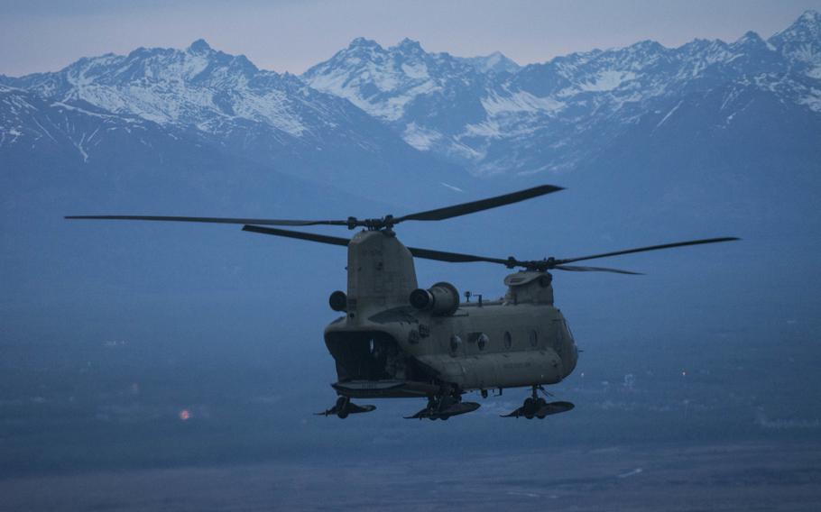 An Alaska National Guard CH-47 Chinook filled with paratroopers from 3rd Battalion (Airborne) 509th Infantry Regiment, descends during air assault training over Joint Base Elmendorf-Richardson, Alaska, on May 15, 2015. On Thursday, the Army announced that the Alaska base would lose nearly 60 percent of its active-duty troops as part of a plan to lower the overall force structure by 40,000.


