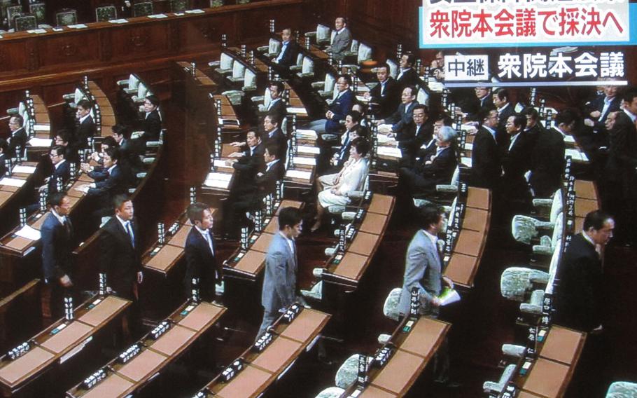 Opposition lawmakers leave the Japan Diet lower house floor on Thursday, ahead of a vote on government-backed bills that would broaden Japan's defense options. The bills passed and will now head to the upper house, where the ruling coalition holds a firm majority.

