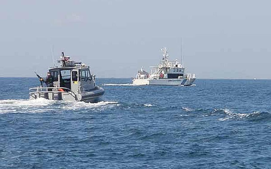 The U.S. Navy's harbor security team works with the Japanese coast guard in Sasebo harbor in this undated photo. The Japanese coast guard plans to deploy more patrol boats to ports in the country’s southernmost island chain to counter increasing Chinese incursions into its territorial waters.