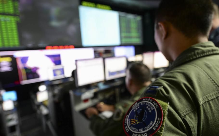 U.S. Air Force Capt. Ernie Chen, of the 961st Airborne Air Control Squadron, coordinates air operations Aug. 17, 2015, with airmen who belong to various units across the globe at the Hardened Theater Air Control Center, Osan Air Base, South Korea.