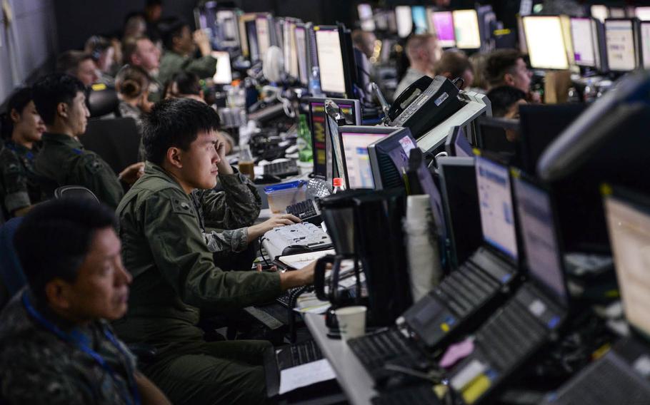 Members from U.S. and South Korean militaries man the Hardened Theater Air Control Center, at Osan Air Base, South Korea, during the first day of Ulchi Freedom Guardian, Aug. 17, 2015. Portions of the image were blurred for security concerns.