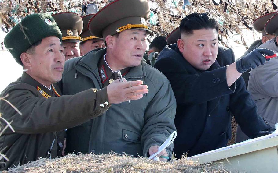 A photo released by KCNA news agency on March 12, 2013, shows North Korea leader Kim Jong Un, right, visiting the Wolnae-do Defence Detachment.