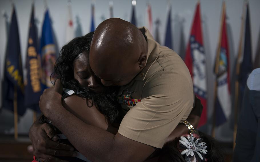 Chief Aviation Machinist's Mate Teyronn Jackson of Strike Fighter Squadron 27 hugs his wife, Joytonia, after receiving his anchors during the chief petty officer pinning ceremony at Naval Air Facility Atsugi, Japan, on Sept. 15, 2015. 