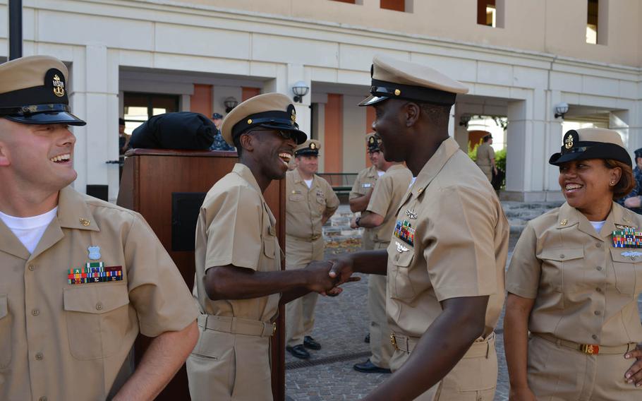 Chief Petty Officer Ray Newton, left, congratulates newly pinned Chief Petty Officer Willie Sheppard following a pinning ceremony Wednesday, Sept. 16, 2015, at the U.S. Navy base in Naples, Italy.
 
