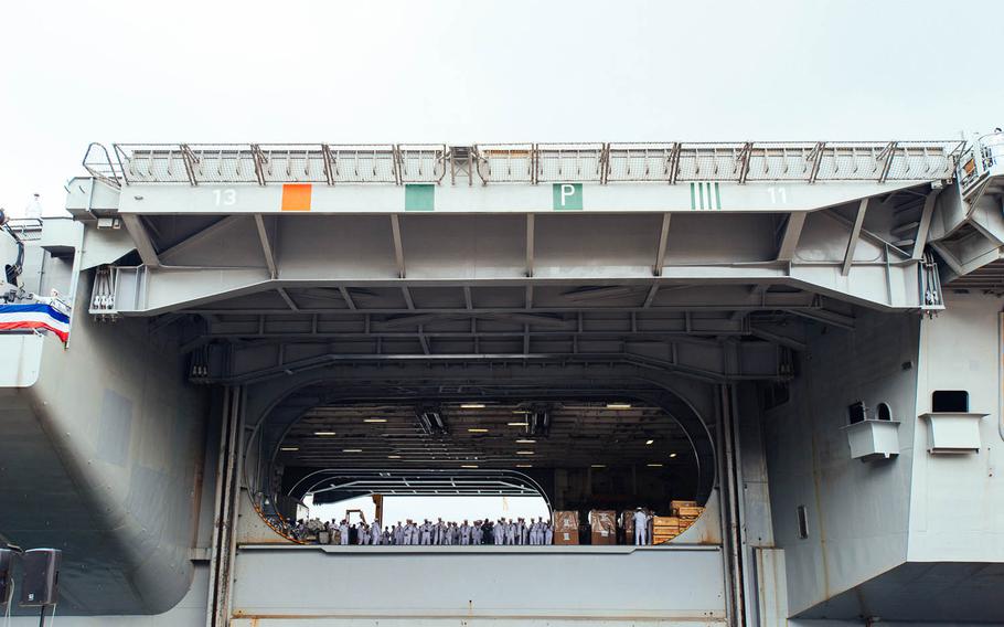 Crewmembers aboard the aircraft carrier USS Ronald Reagan wait to be reunited with their families after arriving Oct. 1, 2015, at Yokosuka Naval Base, Japan. The Ronald Reagan's deployment is part of Washington's "Pacific Pivot," reflecting the Obama administration's view of the region as its highest long-term priority.