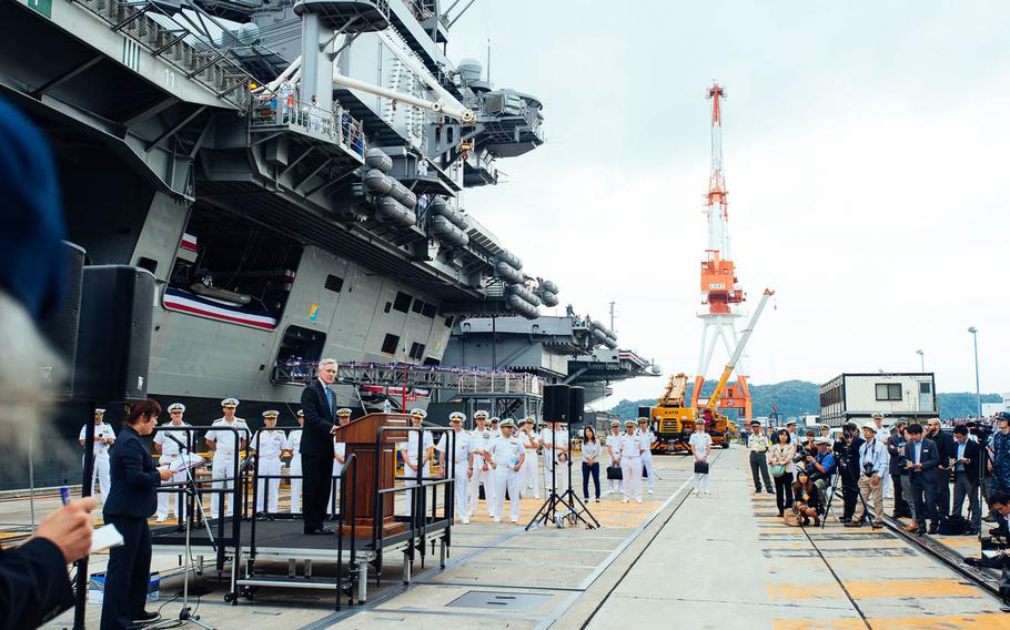 Servicemembers, guests and the media listen to Secretary of the Navy Ray Mabus make remarks Oct. 1, 2015, after the USS Ronald Reagan's arrival at Yokosuka Naval Base, Japan. 