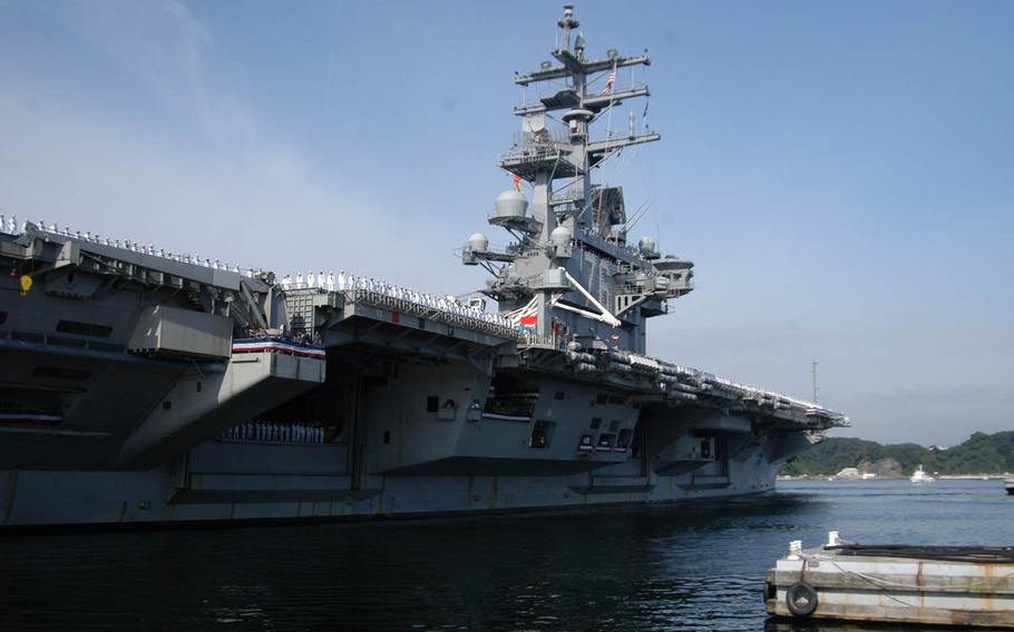 Sailors aboard the USS Ronald Reagan man the rails as the nuclear-powered aircraft carrier pulls into port Oct. 1, 2015, at Yokosuka Naval Base, Japan. An electrical fire burned an aircraft aboard the USS Ronald Reagan on Sunday, just hours before Prime Minister Shinzo Abe visited the aircraft carrier. No injuries were reported. 


