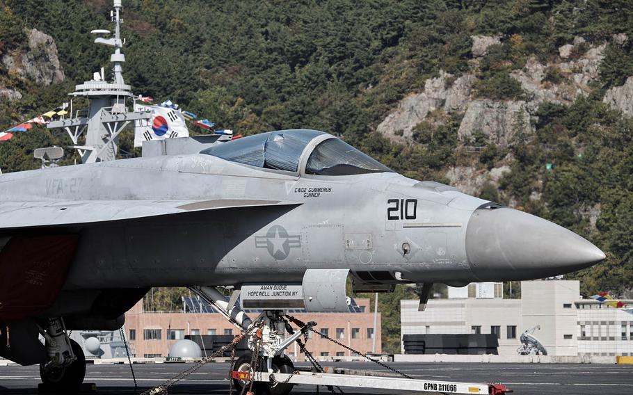 An F/A-18 Super Hornet sits on the flight deck of the aircraft carrier USS Ronald Reagan with the South Korean flag in the background Friday, Oct. 30, 2015 in Busan, South Korea.