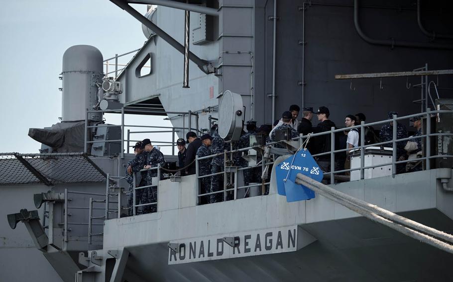 Crewmembers from the aircraft carrier USS Ronald Reagan gather on the fantail after arriving in Busan, South Korea, Friday, Oct. 30, 2015.