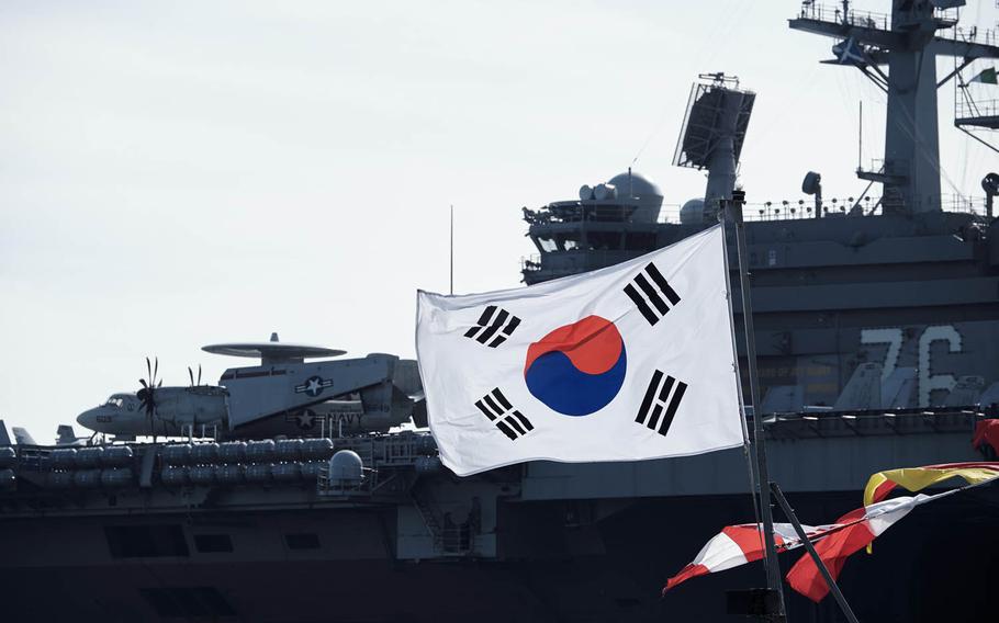 The South Korean flag waves in front the aircraft carrier USS Ronald Reagan Friday, Oct. 30, 2015 in Busan, South Korea.