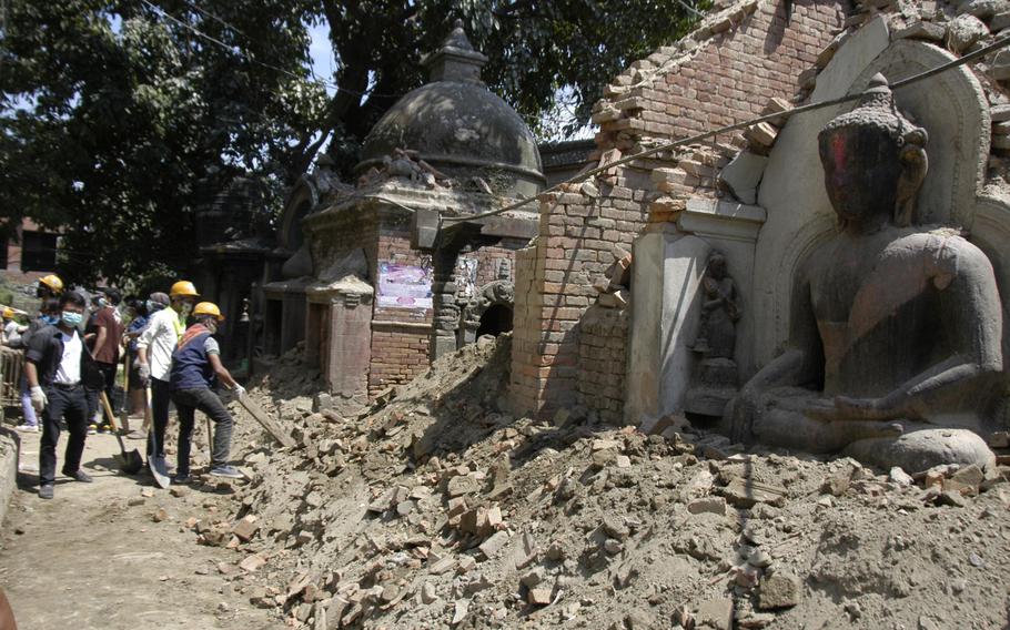 Workers clear rubble from an earthquake damaged religious site at Bhaktapur, Nepal, in May 2015. Six U.S. Marines who died during the earthquake-relief efforts in Nepal will be honored in a ceremony Friday, Nov. 6, 2015, at the U.S. Embassy in Kathmandu.