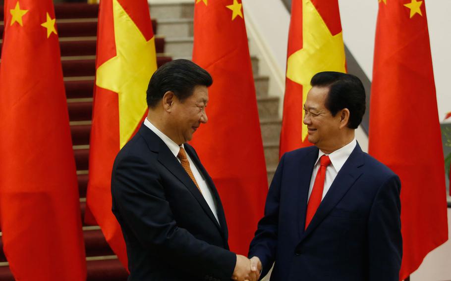 Chinese President Xi Jinping, left, shakes hands with Vietnam's Prime Minister Nguyen Tan Dung before their meeting at the Government Office in Hanoi Thursday, Nov. 5, 2015. Xi's meetings in Vietnam beginning Thursday follow the communist countries' efforts to repair ties strained over disputes in the South China Sea.