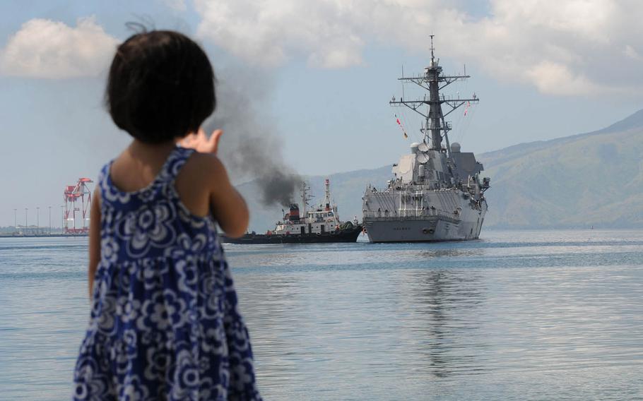 A Philippine child waves as the guided-missile destroyer USS Halsey gets underway after participating in Cooperation Afloat Readiness and Training Philippines in 2010. The Philippines has asked the U.S. to conduct joint naval patrols in the South China Sea as tensions rise with China over resources and freedom of navigation in the Asia-Pacific region.